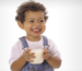 Smiling child drinking milk for healthy growth and bone development