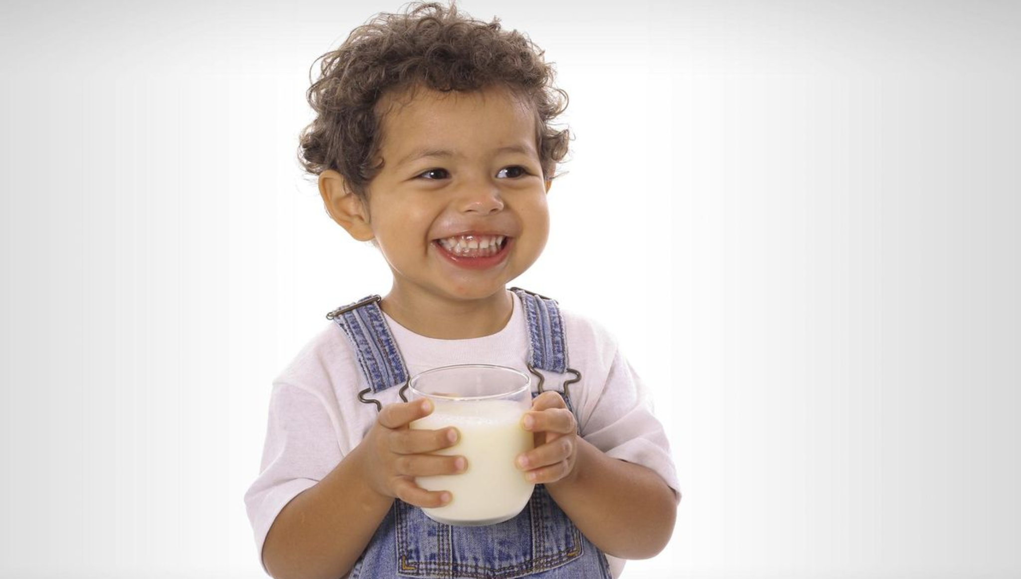 Smiling child drinking milk for healthy growth and bone development