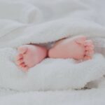 newborn baby feet wrapped in blanket best baby care products essential