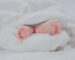 newborn baby feet wrapped in blanket best baby care products essential